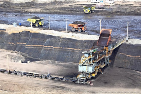 view of a construction site with trucks and conveyor belt